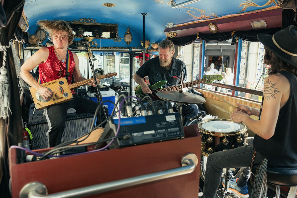 Band members jamming out on the Fender Bender bus tour