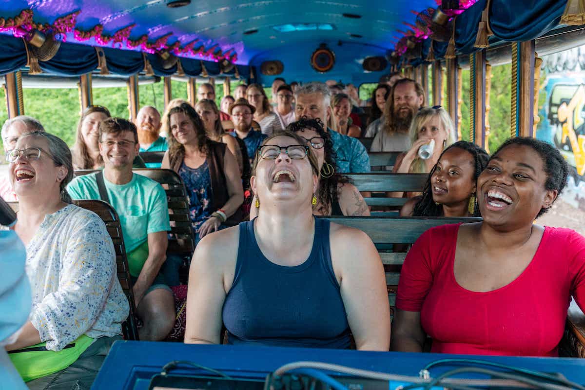 Photo of a full bus, either screaming or laughing. It's hard to tell!