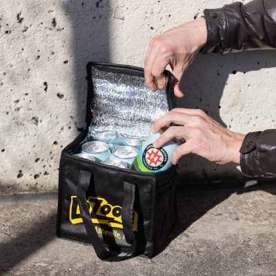 Small drink cooler holding 6 cans of beer- black drink cooler with silver insulation inside and yellow LaZoom logo on the exterior