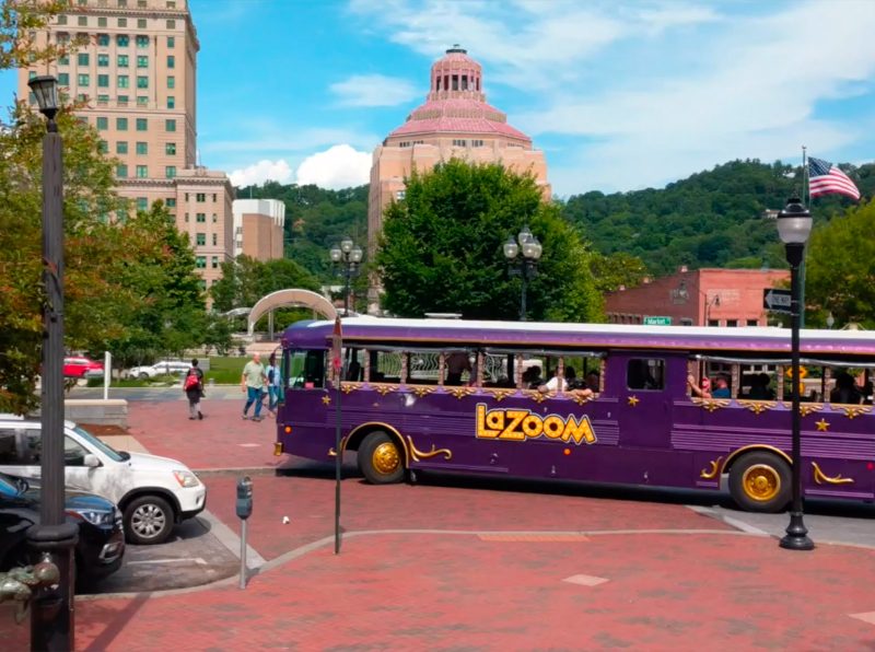 Comedy Bus Tour - LaZoom Tours purple driving past the Asheville Courthouse.